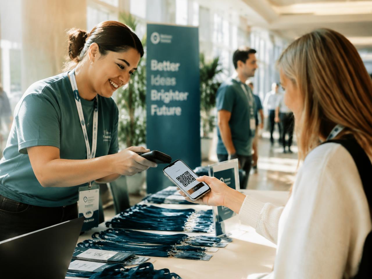 Volunteer scanning an attendee's QR pass at a registration desk
